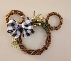 a mickey mouse head made out of twigs with a black and white bow on it