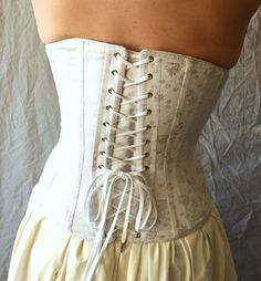 "Our c. 1880 Alice Victorian corset is designed to be worn with the long, close-fitting cuirasse bodices of the 1880s. Ideal shaping when worn with your Victorian costumes and Victorian clothing or for a bridal corset. Either worn alone as part of your wedding dress or as an undergarment this style is generously boned giving the wearing an extreme nipped in waist. Also a great addition to any Cosplay costume or Steampunk ensemble. The front panels allow a generous fullness in the bust and hips w Cosplay Corset, Victorian Corset, Bridal Corset, Victorian Costume, Lace Tights, Victorian Clothing, Aesthetic Things, Costume Cosplay, Cosplay Costume