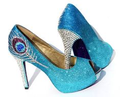 a pair of blue high heeled shoes with crystals on them