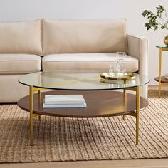 a living room with a couch, coffee table and vases on the side tables