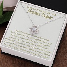 This Masters Degree Graduation Gift for Her would be a beautiful keepsake for receiving her Masters Degree. Give this for her graduation day and show her how proud you are of her. This is perfect for a friend, sister, daughter, granddaughter or anyone who has earned her Masters Degree. ✦ AT A GLANCE:- 14k white gold finished over stainless steel- The beautiful knot swings from an adjustable cable chain, fastened securely with a lobster clasp. The center cubic zirconia crystal measures 6mm in dia Elegant Valentine's Day Necklace With Message Card, Elegant Necklaces For Anniversary Gift With Message Card, Elegant Mother's Day Jewelry With Message Card, Elegant Necklace With Message Card For Anniversary, Elegant Personalized Jewelry For Graduation Gift, Elegant Wedding Jewelry With Certificate, Elegant Gold Jewelry For Graduation, Silver Jewelry For Graduation And Mother's Day, Elegant Jewelry With Certificate For Anniversary