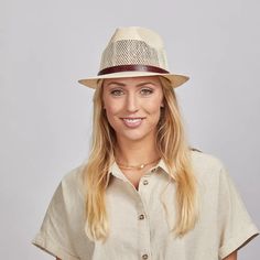 Smiling girl in a cream top and a straw sun hat Classic Fedora Hat With Upf 50+, Beige Toquilla Straw Fedora Panama Hat, Travel Fedora Straw Hat, Classic Straw Hat With Short Brim And Upf 50+, Classic Straw Hat With Upf 50+ And Short Brim, Upf 50+ Flat Brim Fedora For Warm Weather, Natural Panama Hat With Upf 50+, Adjustable Short Brim Fedora For Warm Weather, Natural Fedora Panama Hat