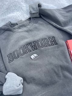 Calling all true bookworms! This sweatshirt is perfect for you- with its super comfortable fit and high-quality feel, it's sure to keep you looking cute but still warm. This is a Comfort Colors brand sweatshirt and will not disappoint in comfortability. You pick the sweatshirt color and thread color - please list the requested thread color in the personalization box. If there is a color you have in mind other than the ones listed, send me a message and I can help.  -Sweatshirt brand: Independant Bookish Sweatshirt With Letter Print And Crew Neck, Cotton Letter Print Bookish Sweatshirt, Bookish Cotton Sweatshirt With Letter Print, Book Lovers Book, Patchwork Sweatshirt, Navy Crewneck, Gifts For Book Lovers, Inspirational Tshirts, Fun Sweatshirts