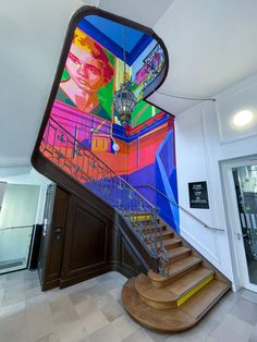 the staircase is decorated with colorful paintings on it