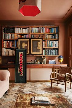 a living room filled with lots of books and furniture