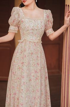 Square neck midi dress with short puff sleeves, lace trims and a lace up corset waist on a floral print and embroidered fabric. Concealed back zipper. S: 33" chest, 26.5" waist, 42.5" lengthM: 34.5" chest, 28" waist, 42.5" lengthL: 36" chest, 29.5" waist, 42.5" lengthXL: 37.5" chest, 31" waist, 42.5" length Floral Dress Aesthetic, Square Neck Puff Sleeve Dress, Flower Printed Dress, Square Neck Midi Dress, Floral Dress Outfits, Teacher Clothes, Lace Neck, Frock For Women, Lace Up Corset