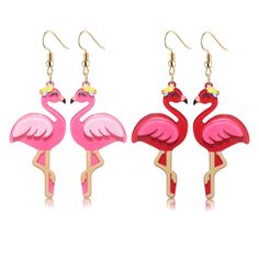 three pink flamingos standing next to each other in front of a white background with gold earrings