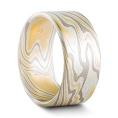 "This set of 10mm Mokume Gane wedding rings are shown in the Twist pattern and the 18k version of our Flare metal combination with a flat profile and an etched finish. The Flare palette features 18k yellow gold, palladium and sterling silver. The first ring also features five flush set stones, one yellow sapphire and four lovely repurposed diamonds provided by the customer. We love having the opportunity to create special pieces like these rings to celebrate new memories with recycled materials! Repurposed Diamonds, Mokume Gane Ring, Woodgrain Pattern, The Flare, Twist Pattern, Mokume Gane, Silver Prices, One Ring, Anniversary Bands