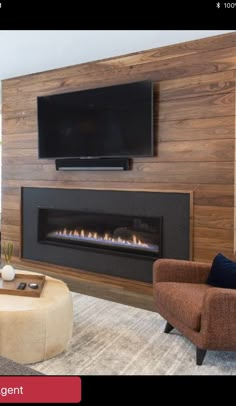 a living room filled with furniture and a flat screen tv mounted on the wall above a fire place