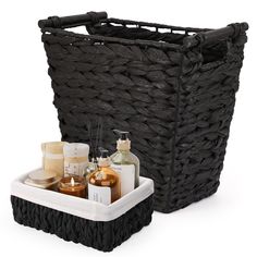 a black basket with soaps and lotions in it