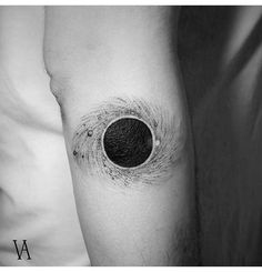 a black and white photo of a man's arm with a hole in it