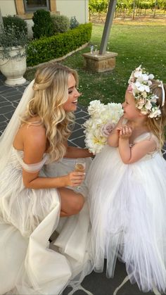 two women in wedding dresses sitting next to each other