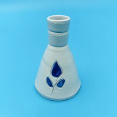 a blue and white vase sitting on top of a table