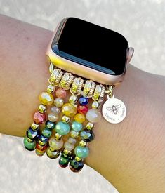 "PLEASE read ENTIRE listing BEFORE purchasing These gorgeous custom watch bands are the perfect arm candy for your Apple Watch! Choose your color scheme and you're ready to rock your arm stack, watch in tow! Made with high quality beads, these bands are great for dressing up your Apple Watch! MEASUREMENTS: *These bands fit 38mm, 40mm, and 41mm Apple Watch faces ONLY and are ONE SIZE to fit an average sized wrist. *I do NOT offer custom sizes, so be absolutely sure that this band will fit your wr Trendy Multicolor Apple Watch Band As Gift, Adjustable Multicolor Apple Watch Band With Round Beads, Multicolor Adjustable Apple Watch Band Gift, Adjustable Multicolor Apple Watch Band As A Gift, Gift Multicolor Adjustable Apple Watch Band, Cape Diablo, Arm Stack, Custom Apple Watch Bands, Beaded Watches