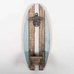 a surfboard mounted to the side of a wall with a coat hanger on it