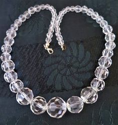 A lovely vintage Art Deco faceted crystal glass bead necklace 18 inches long Spring ring fastening Good condition for its age with some discolouration to fastening area Elegant Round Glass Crystal Necklaces, Vintage Clear Necklaces For Formal Occasions, Vintage Single Strand Glass Jewelry, Vintage Clear Glass Necklace, Vintage Clear Glass Necklaces, Vintage Clear Necklace For Wedding, Vintage Faceted Crystal Necklace, Vintage Glass Jewelry With Round Beads, Vintage Faceted Crystal Necklaces