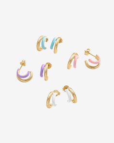 Dive into a world of trendy elegance with our colored enamel huggie earrings. These petite treasures seamlessly merge with any outfit, elevating your look whether it's a daytime casual or evening sophistication. With their compact design, they're as comfortable as they are chic.Materials: 14K yellow or white gold plated. 925 sterling silver posts. Blue, Pink, Purple or White Enamel. Measurements: Outer Diameters: 13mm, and 10.5mm. Width: 6.5mm; Thickness: 2.4mm. Blue Pink Purple, Beaded Necklace Diy, Dangle Necklaces, Necklace Diy, Toggle Bracelet, Beaded Anklets, Pink Enamel, Huggie Earrings, Bracelet Collection