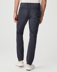 Danford is our modern chino style pant, fitted through the thigh and tapered from the knee to the leg opening. This cotton pant is blended with a slight stretch for maximum comfort without sacrificing a refined look. In a classic navy blue hue, this easy pant will be your new everyday go-to. Navy Business Casual Bottoms With Straight Hem, Navy Bottoms For Business Casual With Straight Hem, Business Casual Tapered Leg Chino Jeans, Slim Fit Pants For Business Casual, Classic Navy Tapered Leg Bottoms, Navy Cotton Chinos Straight Pants, Navy Cotton Straight Chinos, Navy Straight Chinos For Business Casual, Fitted Straight Leg Pants For Elevated Casual Occasions