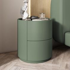 a green round side table next to a couch