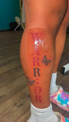 a person with tattoos on their legs and leggings that say, i am warrior