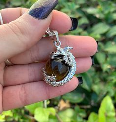 This listing is for a Tigers Eye Dragon Wrap Necklace with a Plated Rhodium Chain. Tiger's Eye is an opaque stone that has a honey yellow to red brown hue. It is typically seen with bands of a silky luster running parallel through the stone. This stone was found in the early 1800's in South Africa. Tiger's Eye is named because of the similarity to the eye of a tiger. Tiger's Eye helps you understand your own needs, especially in relation to others. Due to its appearance, it is thought to be all Necklace Dragon, Raw Fluorite, Honey Yellow, Mens Necklace, Wrap Necklace, Sacral Chakra, Energy Stones, Fluorite Crystal, Dragon Pendant