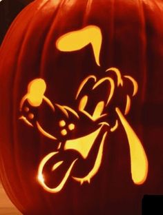 a carved pumpkin with an image of mickey mouse on it's face and ears