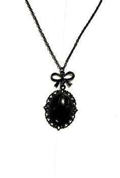 This handmade necklace is completely black, from the chain and clasp to the ribbon charm and shiny oval pendant set in a vintage frame.  This piece is inspired by the dark Victorian era and pairs easily with many outfits. The pendant measures approximately 25 x 35 mm and the necklace is 50 cm long with a lobster clasp closure  Follow @helloween_13 on Instagram Dark Romantic, Filigree Necklaces, Cameo Necklace, Cameo Pendant, Oval Pendant, Vintage Frames, Victorian Era, Pendant Set, Handmade Necklaces