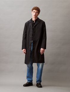 A timeless layer to have on rotation, this trench coat has a tailored silhouette with notch lapels that frame the neckline. Styled with drop shoulders and cut in a regular fit. Detailed with a concealed button placket and slip pockets at the sides.  Material: 67% Cotton, 33% Recycled Nylon. Classic Outerwear With Straight Hem And Concealed Placket, Classic Outerwear With Concealed Placket And Straight Hem, Calvin Klein Button-up Spring Outerwear, Classic Cotton Outerwear With Double Button Closure, Calvin Klein Tailored Notch Lapel Outerwear, Long Cotton Coat With Hidden Button Closure, Classic Outerwear With Relaxed Fit For Office, Calvin Klein Notch Lapel Outerwear For Business Casual, Cotton Long Coat With Hidden Buttons