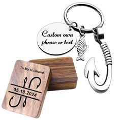 a key chain with a fish on it next to a wooden plaque that says custom own phrase or text