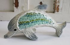 a ceramic fish sculpture sitting on top of a table