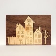 a wooden cutout of a house and tree