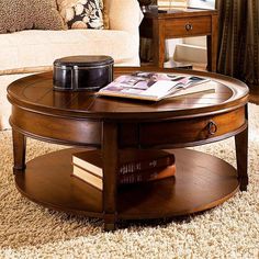 a coffee table with magazines on it in a living room