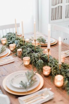 the table is set with candles and plates