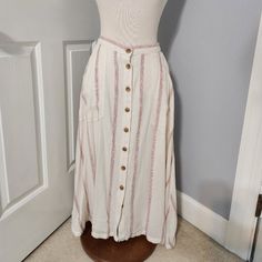 a mannequin wearing a white and pink striped skirt