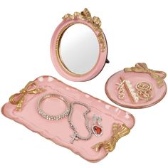 a pink vanity set with jewelry on it