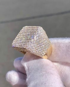 a person wearing a gold ring with diamonds on it