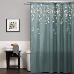 a blue shower curtain with white flowers on it