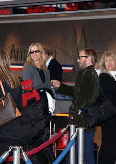 people are waiting in line at an airport