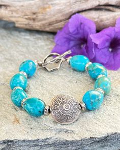 This classic Boho style Turquoise bracelet features amazing Sky blue Turquoise nuggets from the Kingman Mine in AZ. A large round Hilltribe Silver Sun charm is the focal. Each Turquoise nugget is separated by a small fine Silver Hilltribe bead. A Tribal fine silver Toggle is the closure. This Turquoise is so beautiful! Wear alone or stack with your other faves. Classic Boho Style, Black Spinel Necklace, Sundance Style, Southwestern Boho, Sun Charm, Rectangle Earrings, Hill Tribe Silver, Fall Earrings, Crafts Jewelry