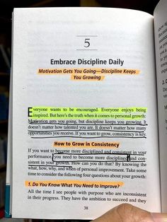 an open book with the words embrace discipline daily written in yellow and green on it