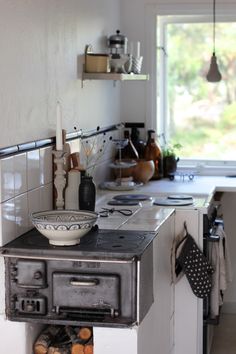 an old fashioned stove in a kitchen with pots and pans on the burners