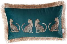 a green pillow with three leopards on it