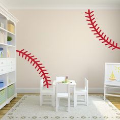 a child's room with a baseball wall decal on the wall and a play table