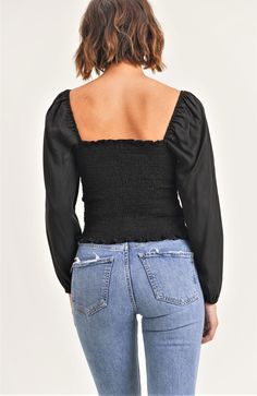 Description Expertly designed for a stunning silhouette, the Abby Top combines a sweetheart neckline, bustier bodice and elastic shoulders and wrists for the perfect fit. Featuring long puff sleeves, a smocked back and a convenient side zipper closure, this top ensures both style and comfort. Product Details and Fit - Sweetheart neckline- Bustier bodice- Elastic shoulders and wrists- Long sleeves- Puff sleeves - Smocked back- Zipper closure on the side Model Measurements - Model is wearing a siz