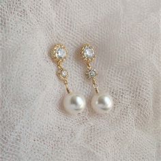 "* Pearl Gold Post Earrings, Wedding Jewelry for Brides, White Pearl Wedding Earrings, Pearl Gold Post Earrings, Wedding Earrings, Pearl Jewelry * Gold-filled wire wrapped crystal white pearl (10mm) and gold tone cubic zirconia teardrop 925 silver silver post. Earrings measure 1 1/4\". * Pearl Silver Post Earrings (shown in the 8th picture) ~ https://www.etsy.com/listing/755858542/wedding-jewelry-for-brides-white-pearl * TAKE 10% OFF $75 OR MORE WITH COUPON CODE ~ WEDDINGS10 * TAKE 15% OFF $100 Elegant Jewelry For Marriage With Matching Earrings, Elegant Drop Bridal Earrings For Wedding Gift, Gold Pearl Crystal Earrings For Wedding, Teardrop Clip-on Earrings For Wedding, Wedding Teardrop Clip-on Earrings, Elegant Gold Bridal Earrings For Wedding Gift, Dainty Gold Bridal Earrings For Wedding, Delicate Dangle Earrings For Mother Of The Bride, Elegant Drop Earrings For Mother Of The Bride