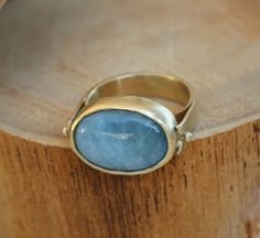 "A unique piece of gemstone ring made elegant with a natural Aquamarine stone, set in bezel of 14k yellow gold fill. A gold ring that has a touch of both classic and modern style. A 14k ring that will suit for everyday use and easy to incorporate into your casual, formal and boho looks. Wear and style with other stackable rings for women and create your own jewelry combinations. Product Details: --------------------- Ring Size: Please select from the drop-down menu. Ring width: 0.19\"/ 4.7mm Sto Oval Large Stone Topaz Ring For Anniversary, Elegant Untreated Oval Emerald Ring, Oval Topaz Ring With Large Stone For Anniversary, Handmade Heirloom Oval Sapphire Ring, Oval Sapphire Ring With Large Stone As Gift, Oval Large Stone Moonstone Wedding Ring, Oval Cabochon Topaz Ring For Anniversary, Untreated Oval Sapphire Ring As Gift, Untreated Oval Ring For Anniversary