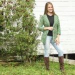 a woman standing in front of a tree