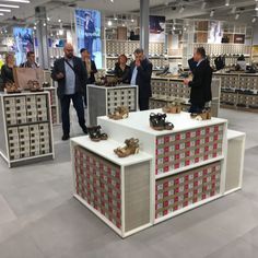 people standing around in a store with shoes on display