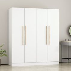 a white cabinet with two doors and some plants on the side table in front of it