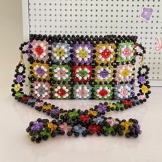 the beaded purse is decorated with multicolored flowers